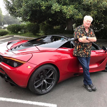 Dave Stall wearing Vintage Tattoo Hawaiian Shirt next to McLaren 720s supercar