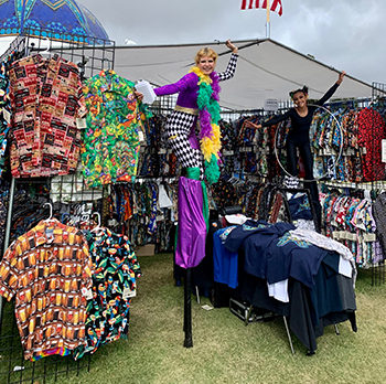 Women on stilts in High Seas trading booth at market